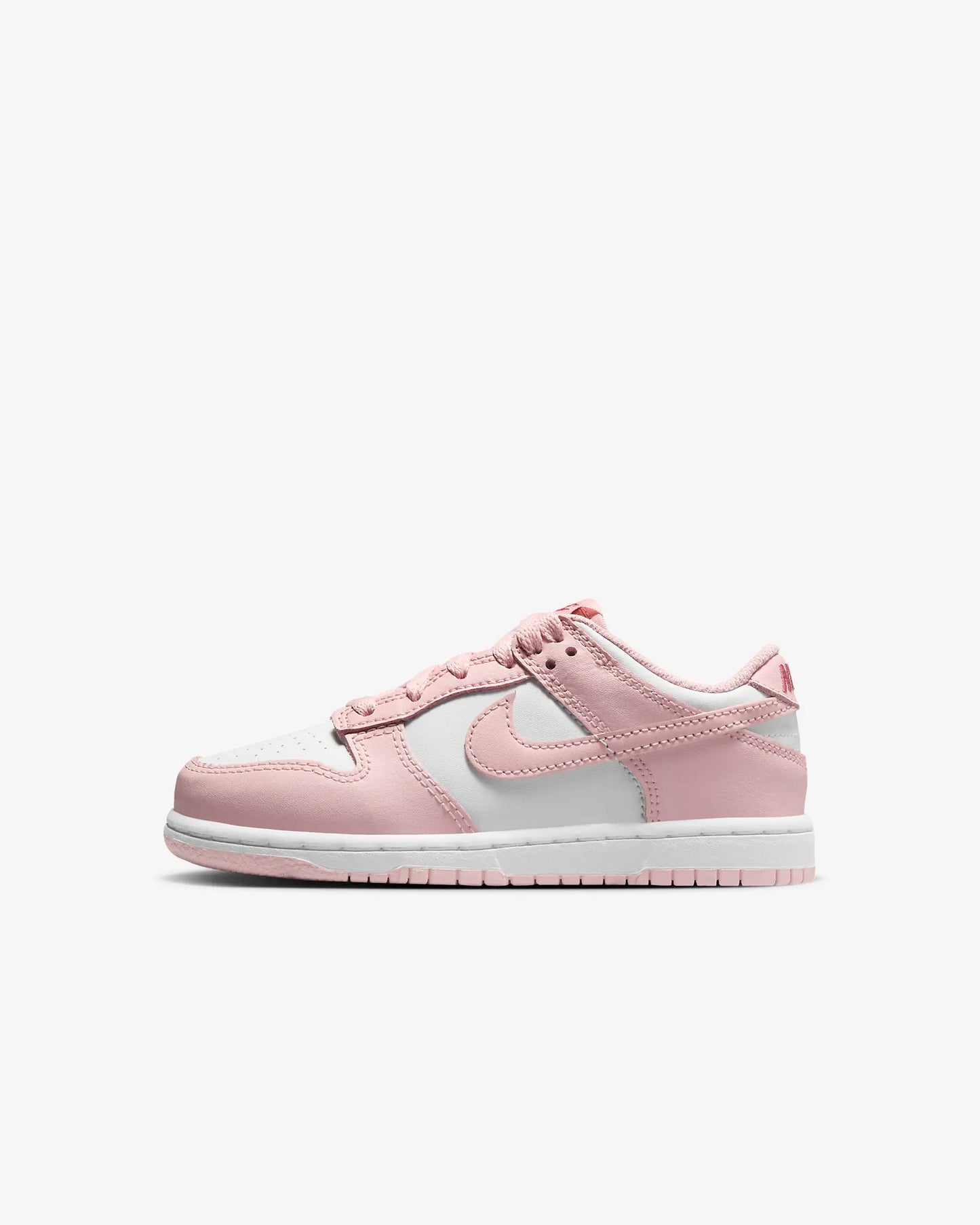 A pair of kids' Dunk Low sneakers in white and pink