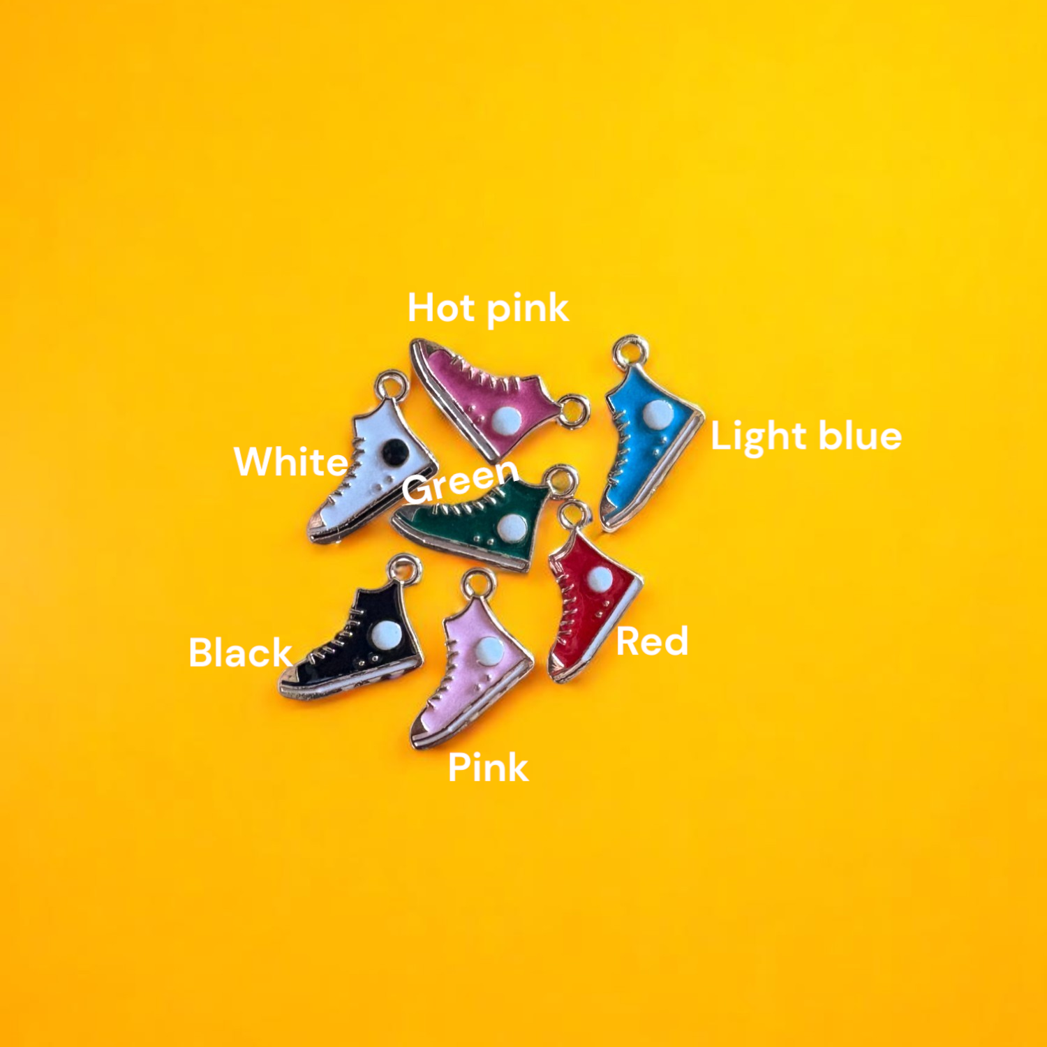 A collection of colorful shoe-shaped charms displayed on a yellow background.