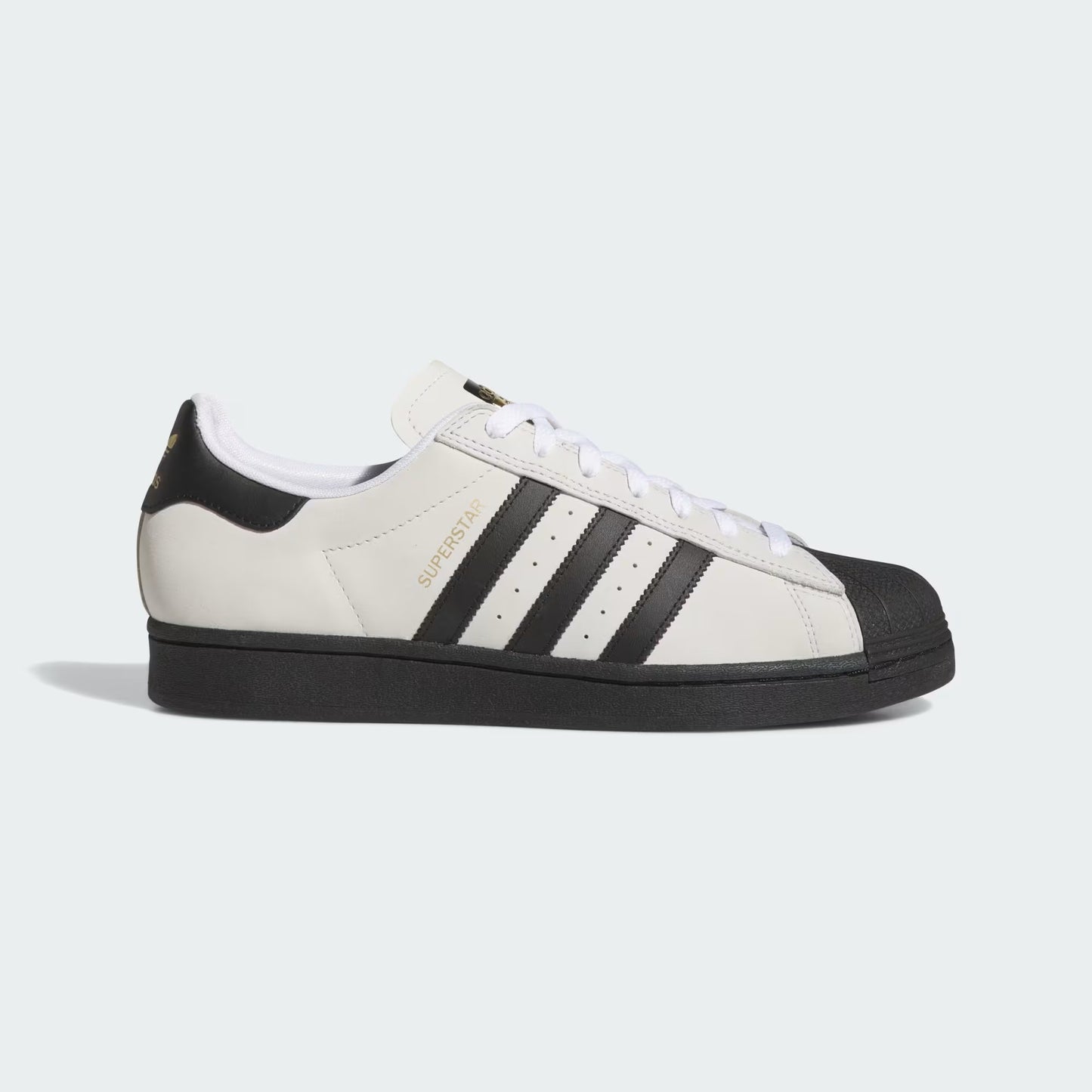 White and black sneaker with three stripes on a light gray background