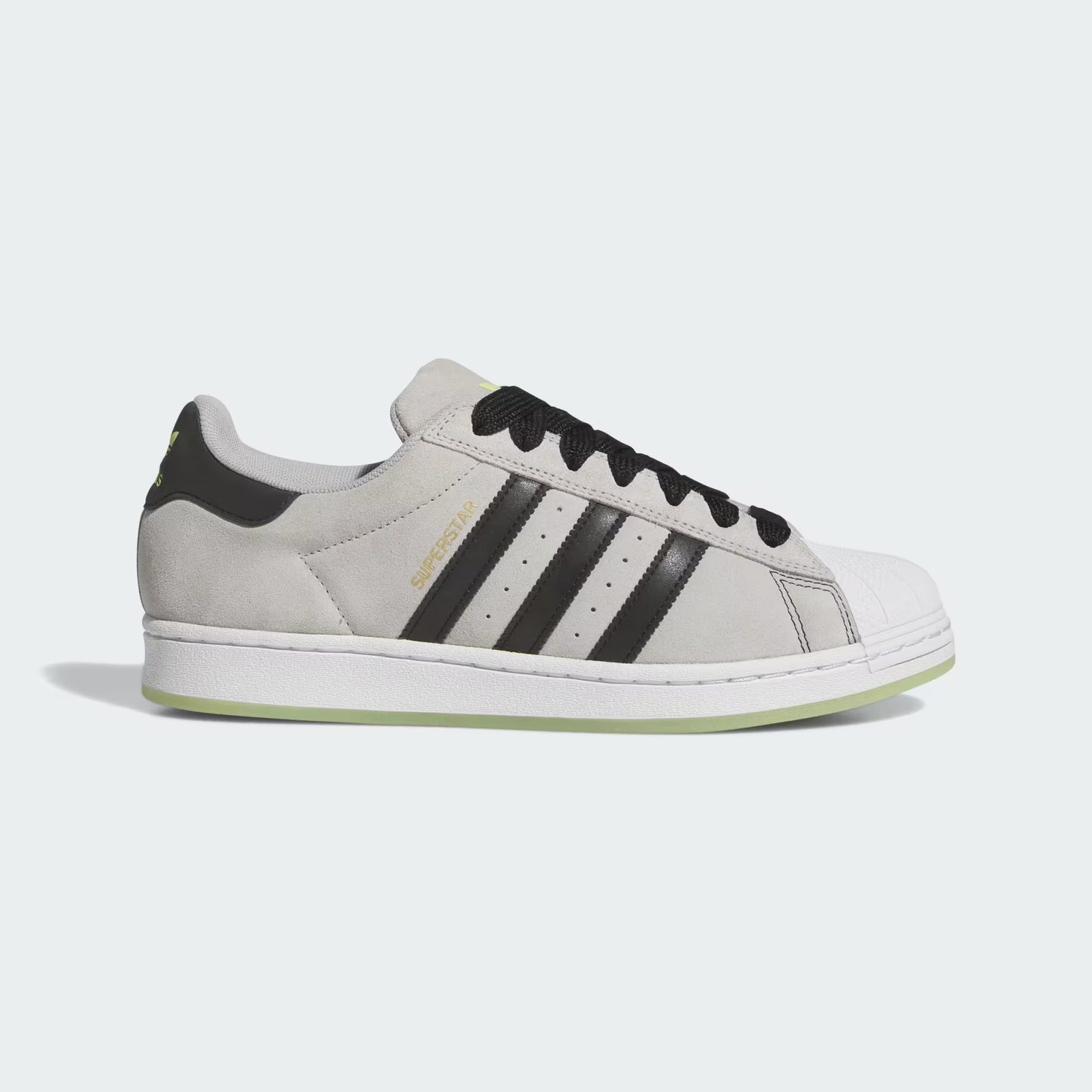 Gray sneaker with black stripes on a light gray background