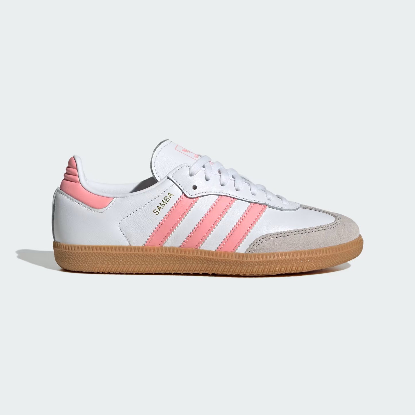 White and pink sneaker with a light brown sole on a white background
