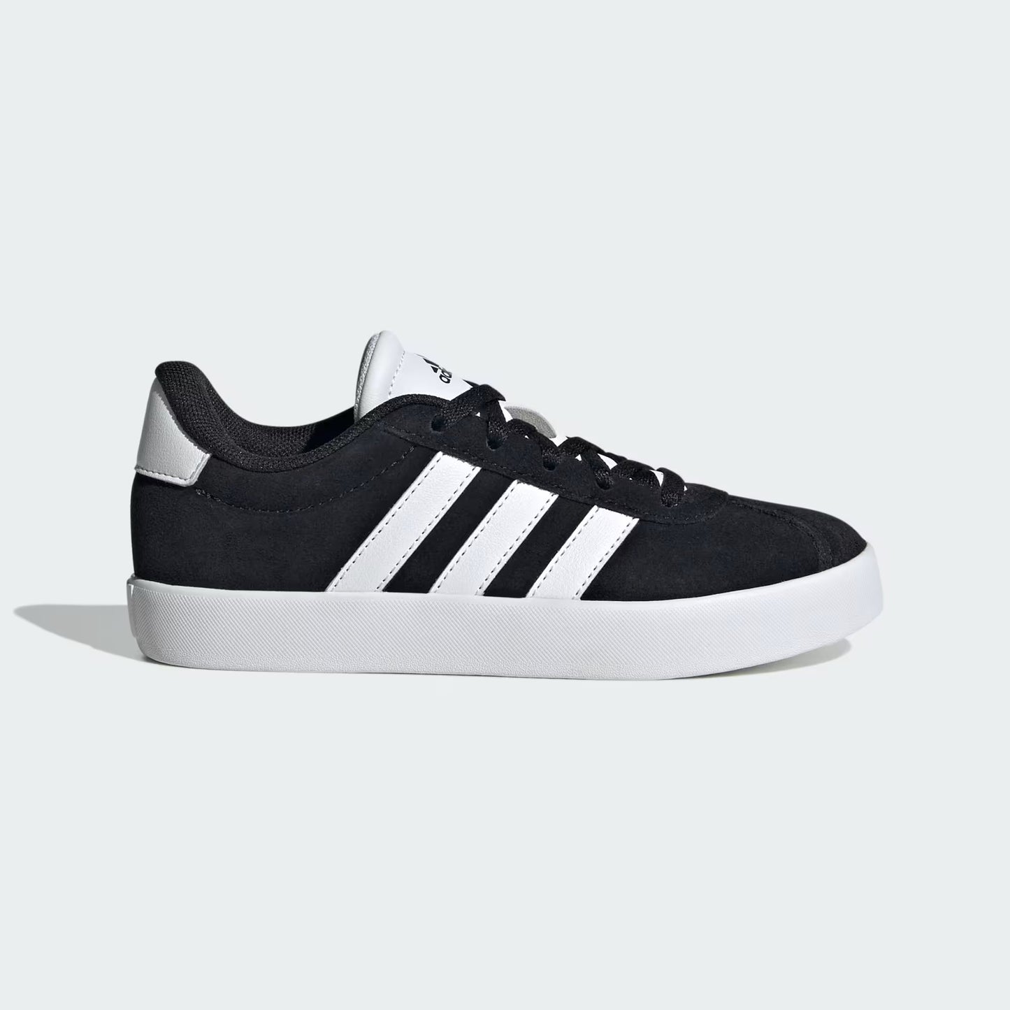 Black sneaker with white stripes on a light gray background