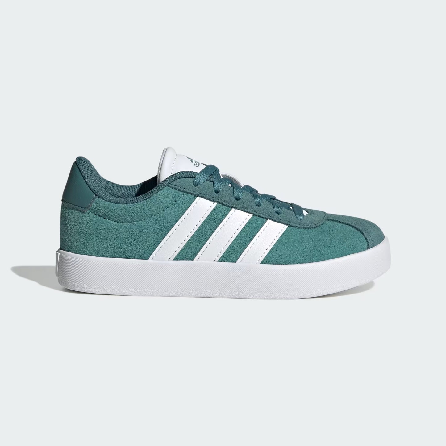 Green sneaker with white stripes on a light gray background