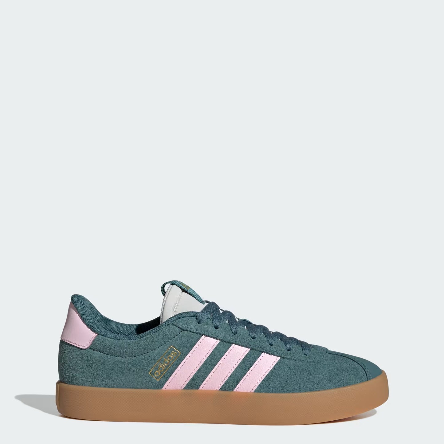 Green sneaker with pink stripes on a white background