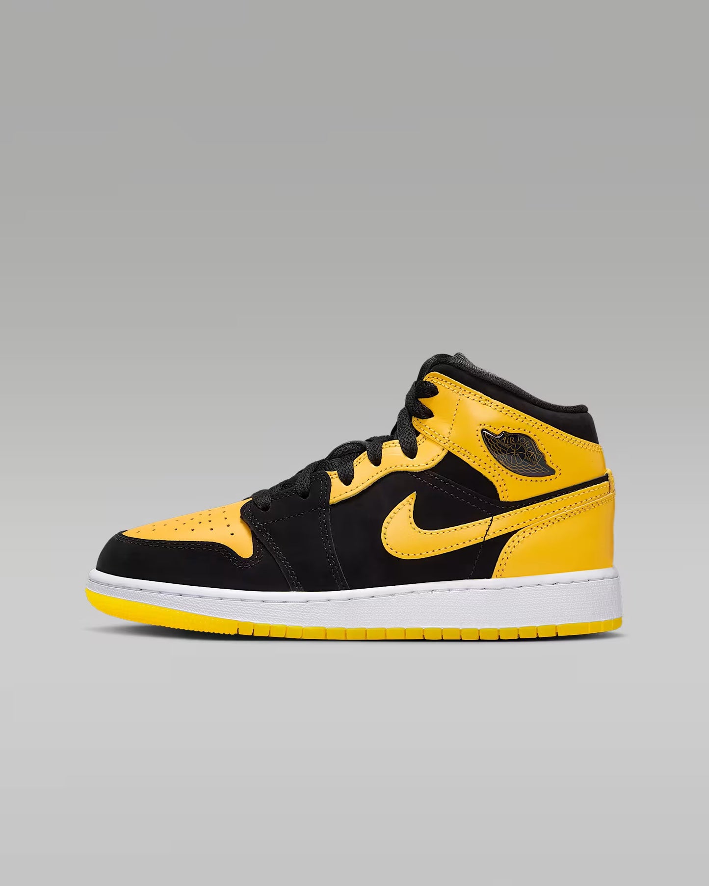 Black and yellow sneaker on a gray background