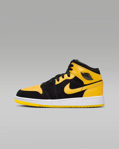 Black and yellow sneaker on a gray background