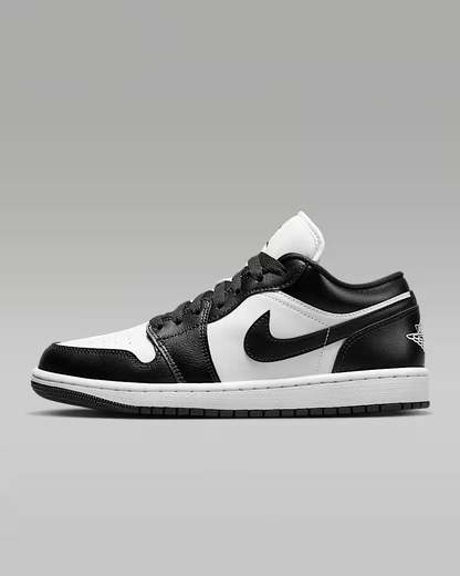 Black and white sneaker with a prominent logo on a gray background