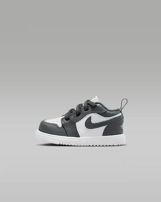 Gray and white sneaker with a logo on a gray background