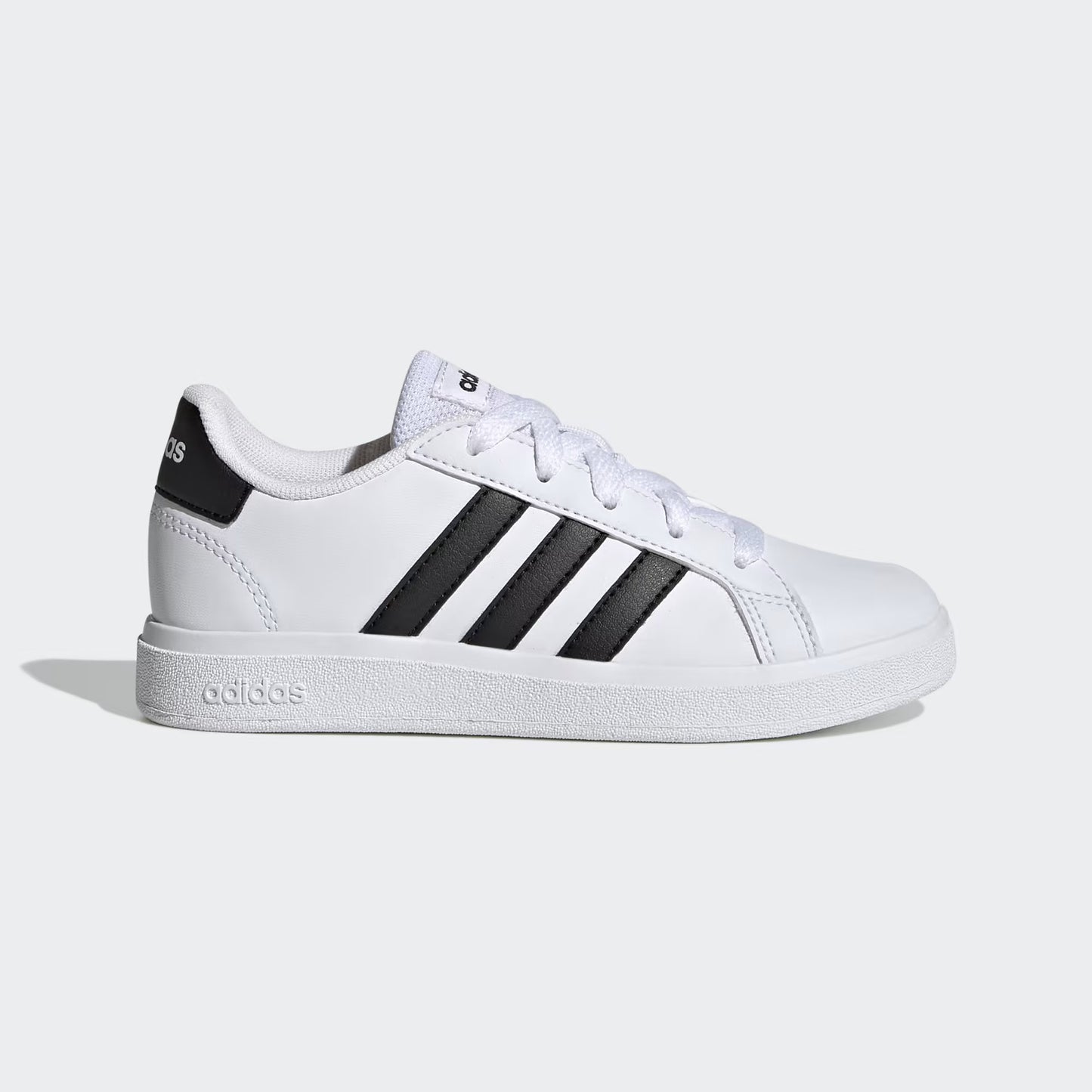 White sneaker with black stripes on a light gray background