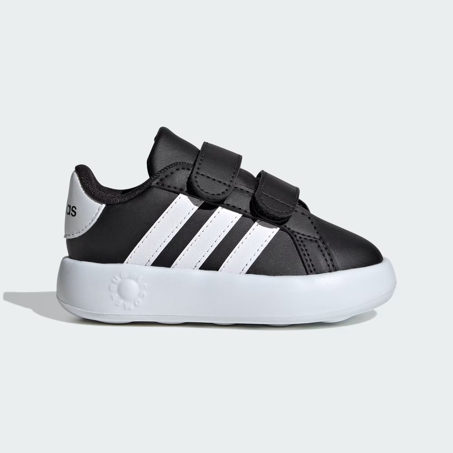 Black and white children's sneakers on a light gray background