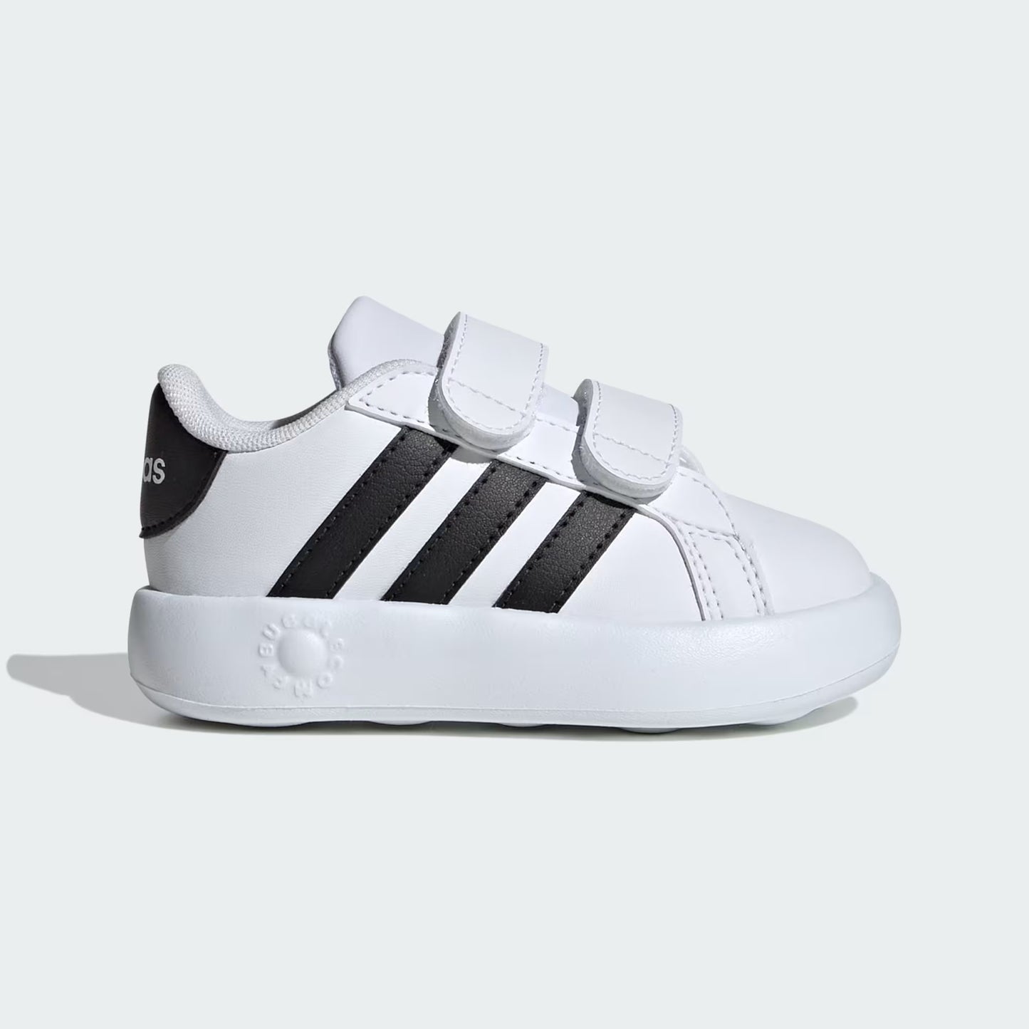 White sneaker with black stripes on a light gray background
