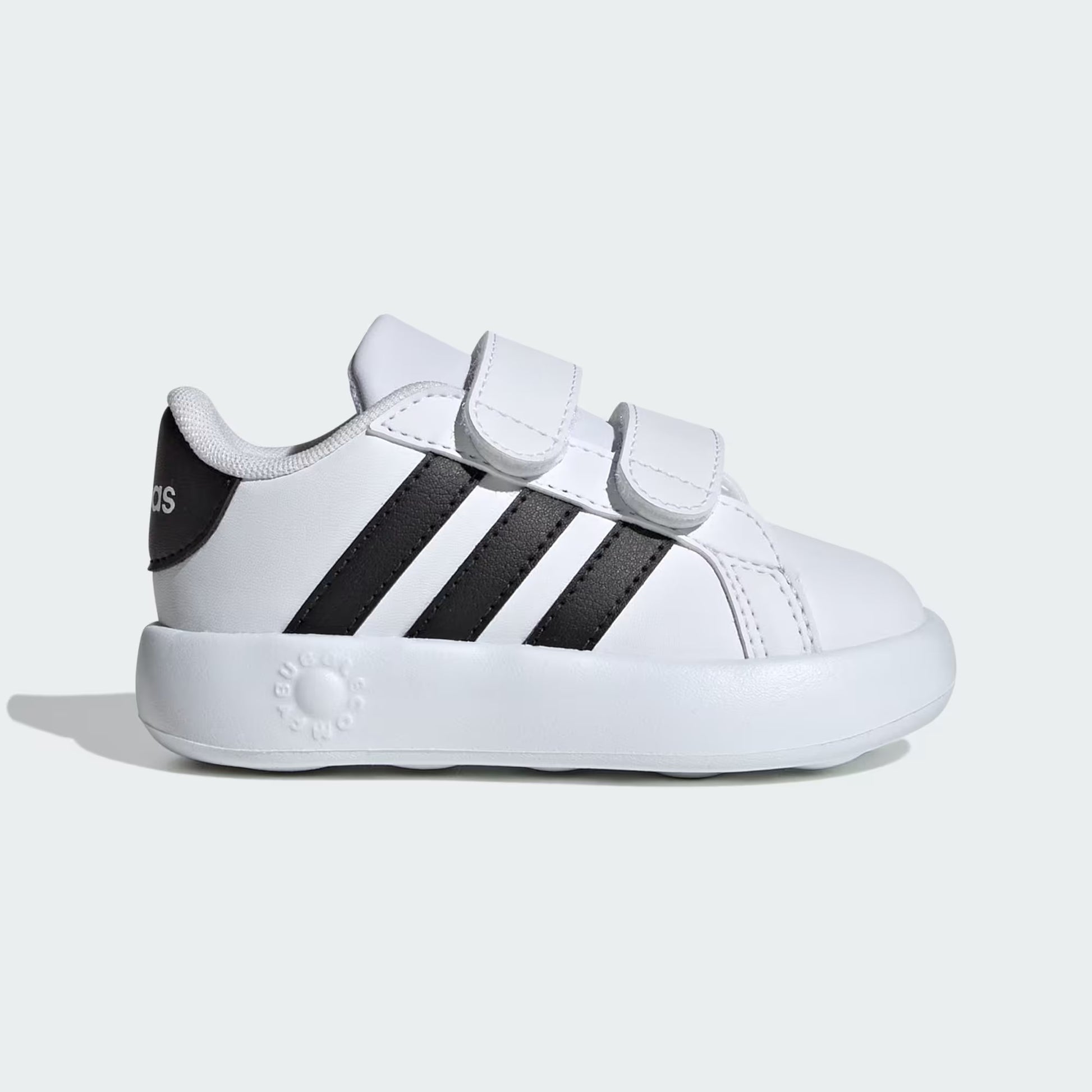 White sneaker with black stripes on a light gray background