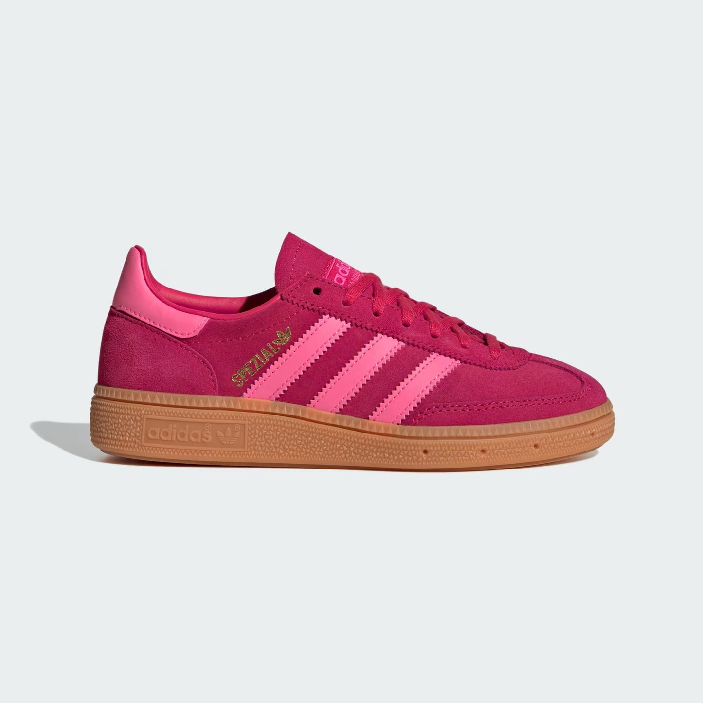 Pink sneaker with gold accents on a light gray background
