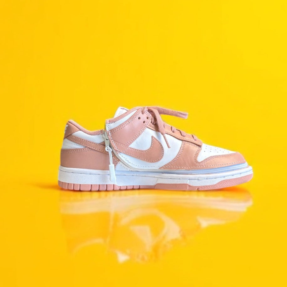 pink and White sneaker on a yellow background. 