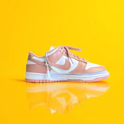 pink and White sneaker on a yellow background. 