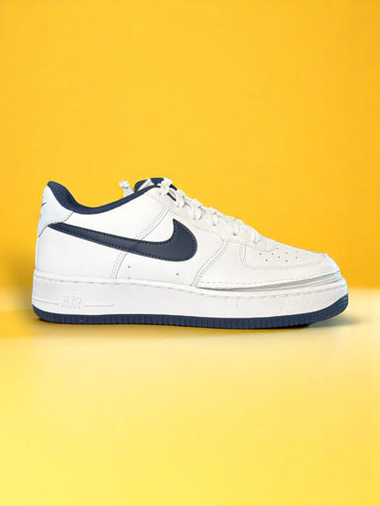 White sneaker with a blue swoosh logo on a yellow background