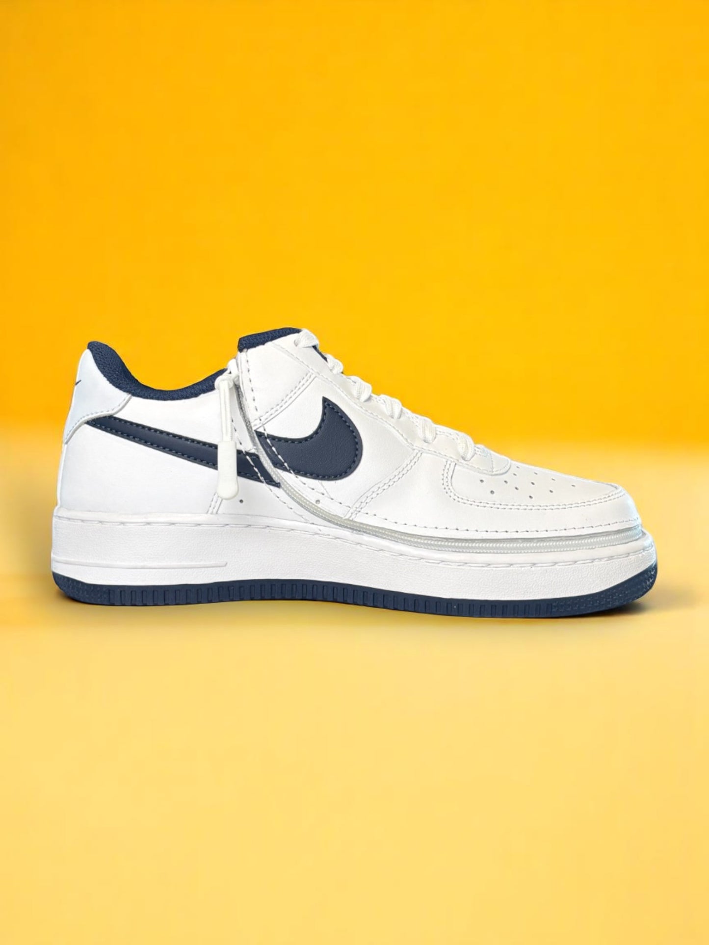 White sneaker with navy accents on a yellow background