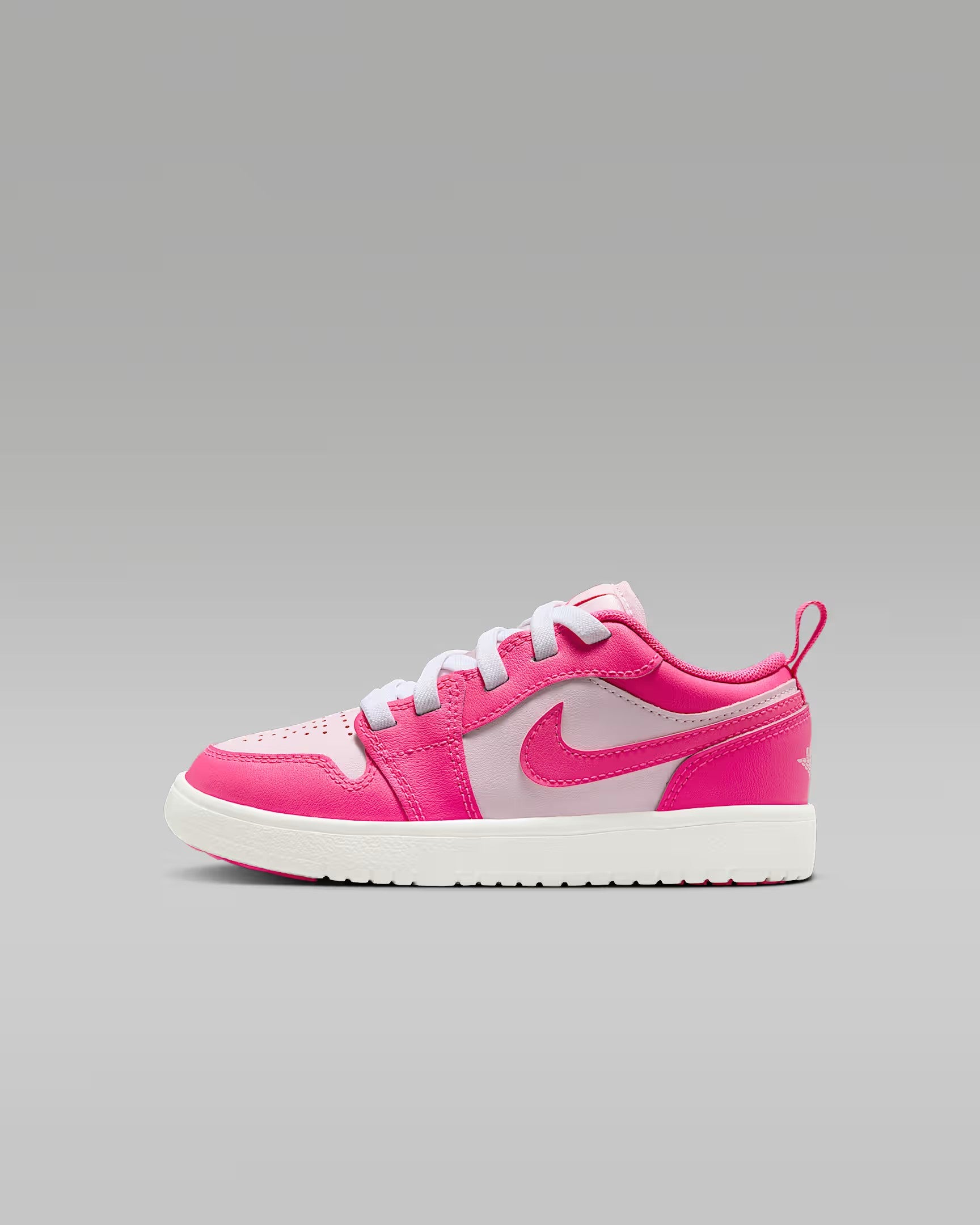 Pink sneaker with a white logo on a gray background