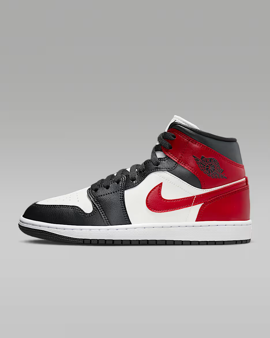 Black, white, and red sneaker with a prominent logo on a gray background