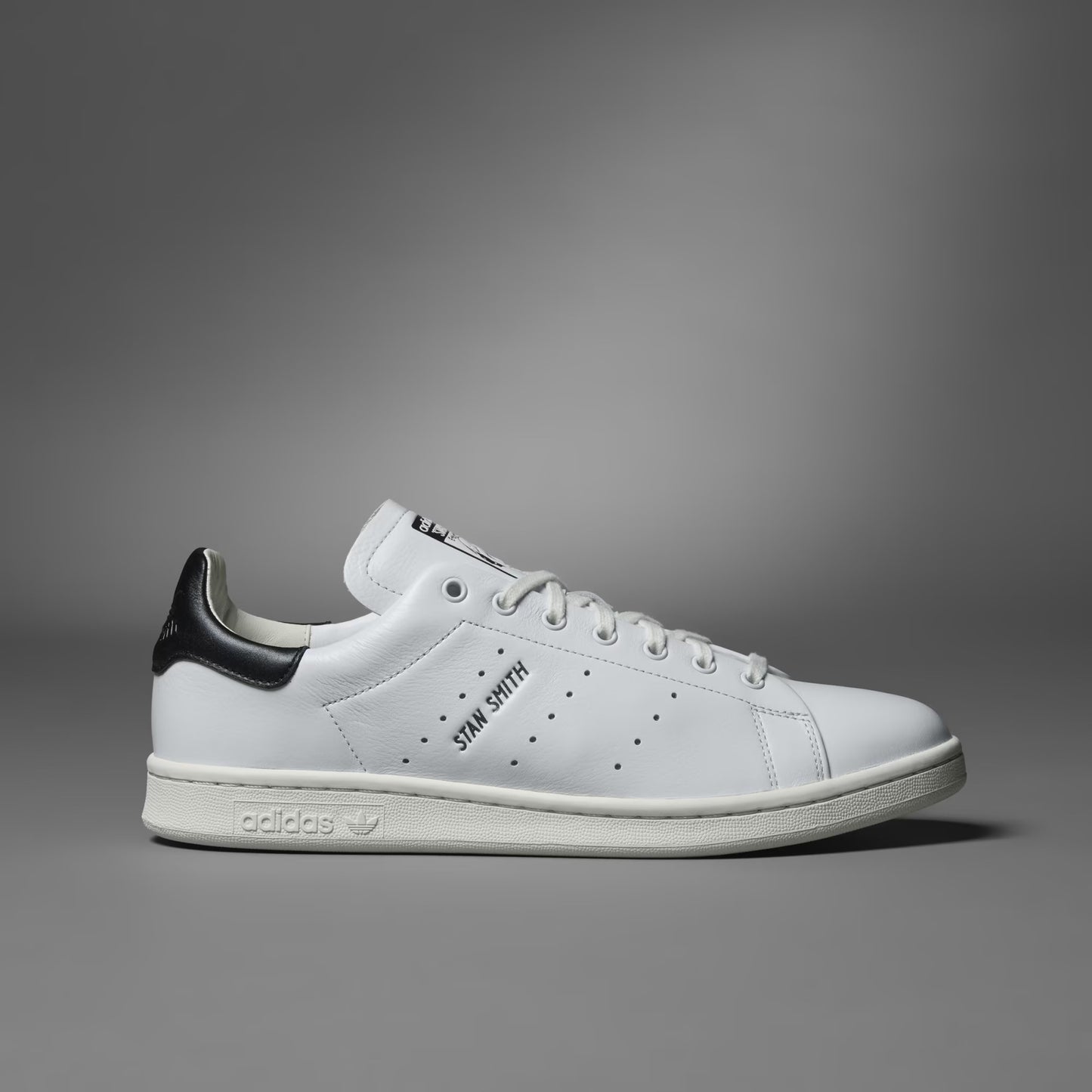 White sneaker with black accents on a gray background
